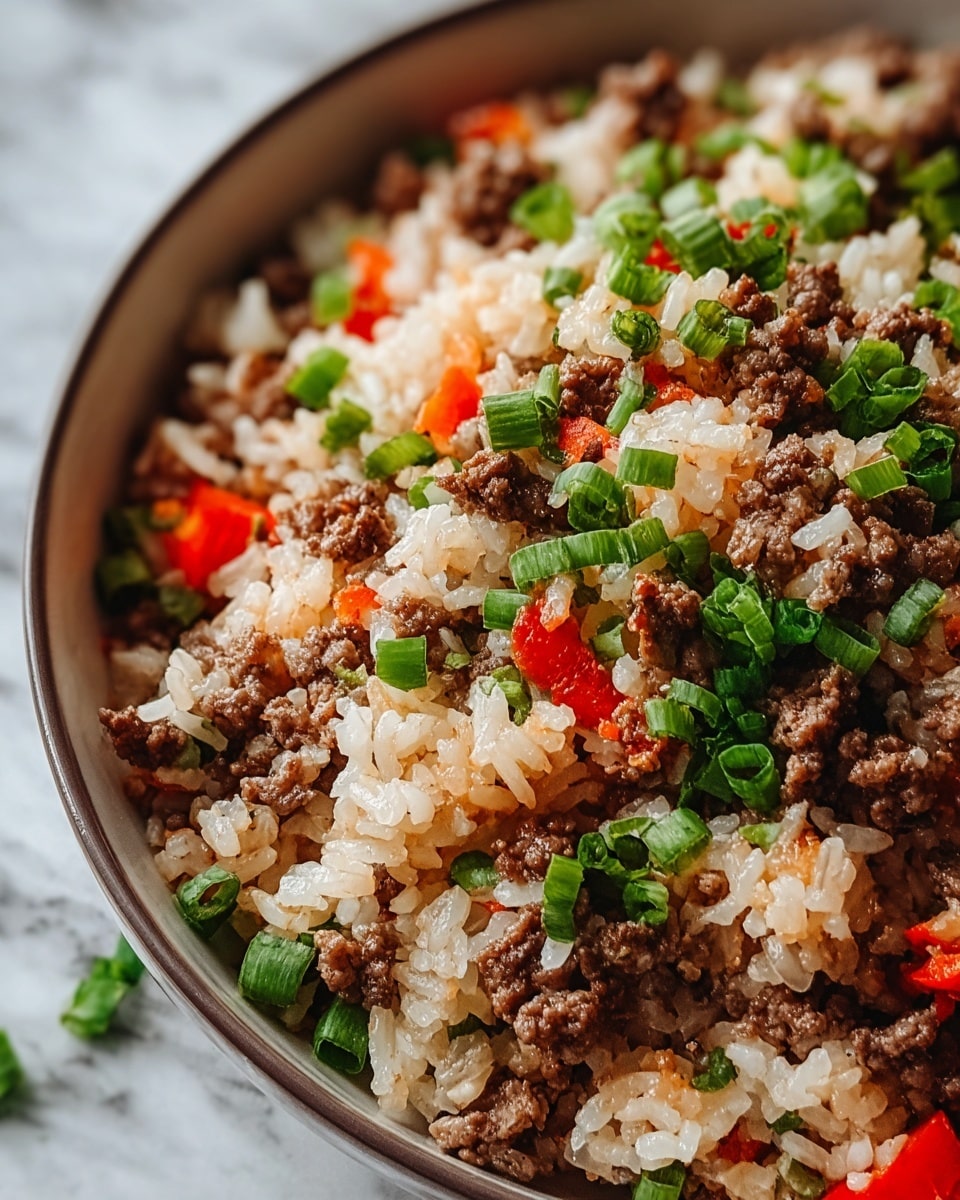 A close-up of a bowl filled with a mix of cooked white rice, ground beef, chopped green onions, and small pieces of red bell pepper, layered evenly and mixed together, showing a texture of soft rice grains and crumbly brown beef with bright green and red vegetable pieces scattered throughout the dish, all inside a white bowl placed on a white marbled surface, photo taken with an iphone --ar 4:5 --v 7