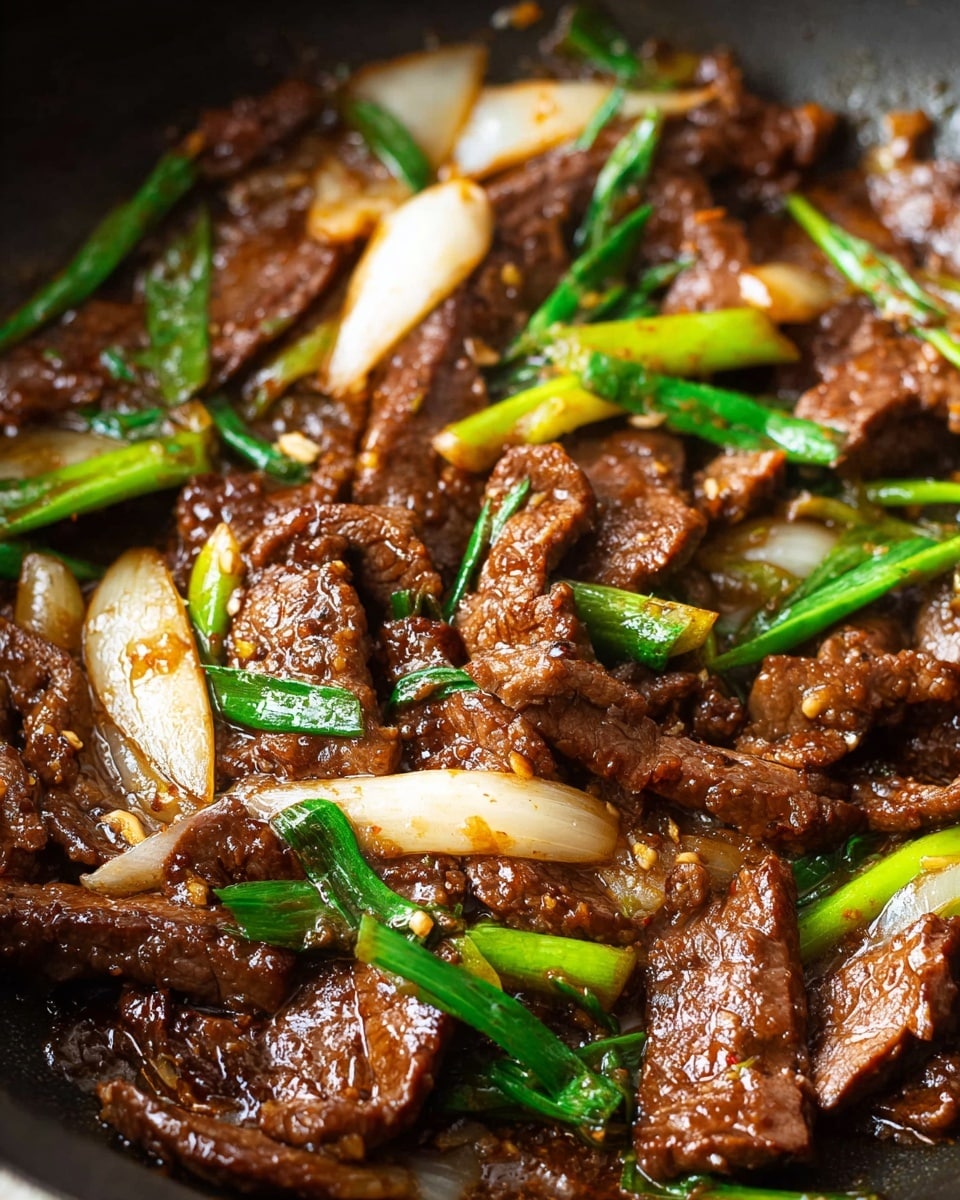 A close-up view of a glossy, dark brown slice of beef held by chopsticks, showing a slightly rough texture with small creases and cooked edges; below, a white plate filled with many pieces of similarly colored beef mixed with green vegetable stalks and leaves, all resting on a white marbled surface. Photo taken with an iphone --ar 4:5 --v 7