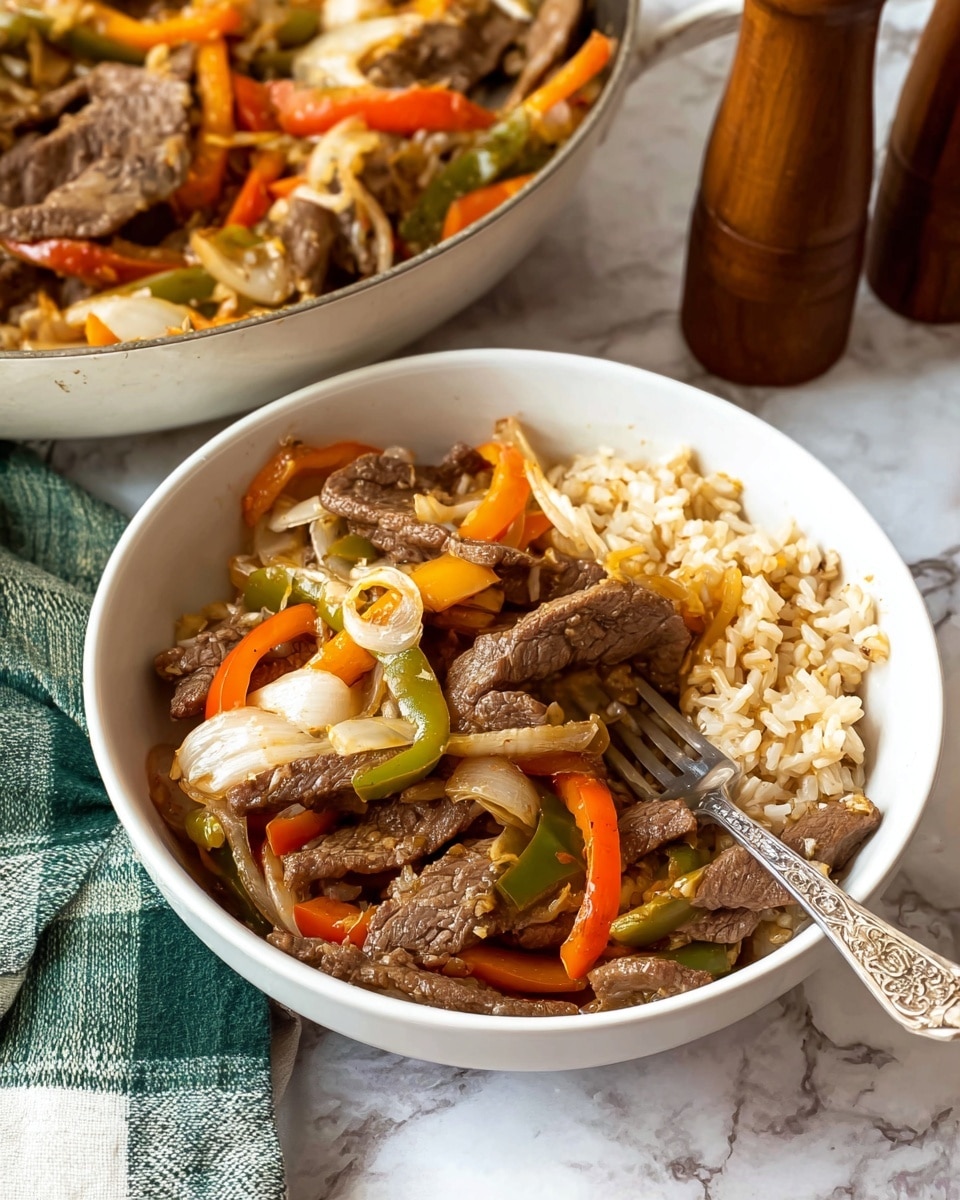 A white bowl filled with three main layers: the bottom layer is light brown rice, the middle layer contains mixed sautéed vegetables including orange bell peppers, green bell peppers, and translucent white onions, and the top layer consists of thin slices of cooked brown beef mixed with melted white cheese strands. A silver fork with an ornate handle rests inside the bowl, spearing some beef and vegetables. The bowl is set on a white marbled surface, near wooden salt and pepper shakers and a green checkered cloth. Behind it, part of a white pan with more beef and vegetables is visible. Photo taken with an iphone --ar 4:5 --v 7