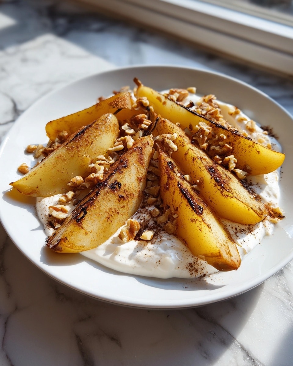 A white plate holds a smooth, thick layer of creamy white yogurt spread evenly at the base. On top, there are seven thin slices of pear with a pale yellow color and slightly translucent texture, each arranged in a loose circular pattern covering most of the yogurt. Light brown cinnamon powder is speckled over the fruit and yogurt. Scattered across the pears and yogurt are small clusters of rough-textured walnut pieces in a medium brown shade. The dish sits on a white marbled surface with natural light casting soft shadows across the plate. photo taken with an iphone --ar 4:5 --v 7