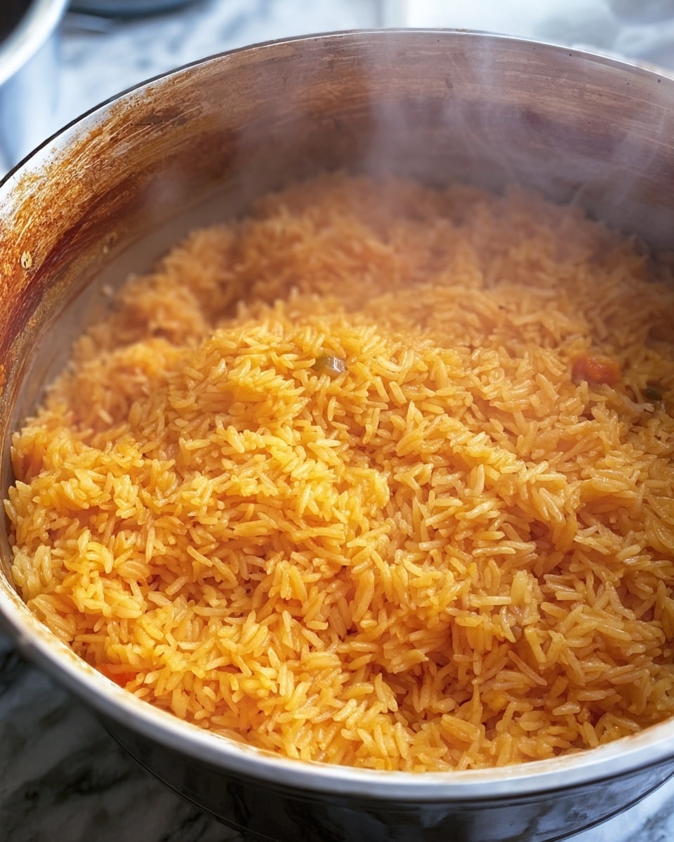 A close-up view of a pot filled with cooked yellow-orange rice, showing individual grains that look soft and fluffy. The rice layers have a slightly moist texture with small bits of what appear to be vegetables or spices mixed in. The pot’s rim has some brown stains from cooking. The background is a white marbled texture, and a bit of steam rises gently from the hot rice. Photo taken with an iphone --ar 4:5 --v 7