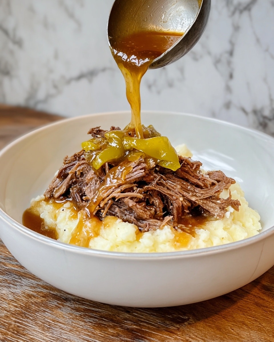 A white bowl holds a layered dish with creamy white mashed potatoes as the base layer, topped by a heap of shredded brown beef. On top of the beef, there is a whole yellow-green pepper. A ladle is pouring a shiny, rich reddish-brown sauce over the beef, creating a glossy drip that falls toward the bowl. The bowl sits on a wooden surface with a soft focus background, showing a black pan. Photo taken with an iphone --ar 4:5 --v 7