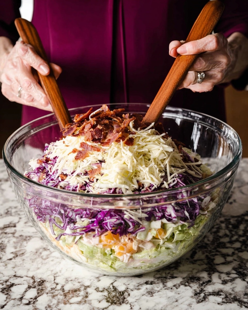This image shows a close-up of a clear glass bowl with several colorful layers of salad ingredients arranged inside. The bottom layer is bright purple shredded cabbage, followed by a layer of light green chopped cabbage. Above that is a mix of finely chopped orange, yellow, and purple vegetables, likely carrots, bell peppers, and onions. The fourth layer consists of white shredded cabbage, topped with pieces of crispy brown bacon. The textures vary from crunchy cabbage to crunchy bacon, creating a visually rich mix. The background is a white marbled texture. photo taken with an iphone --ar 4:5 --v 7